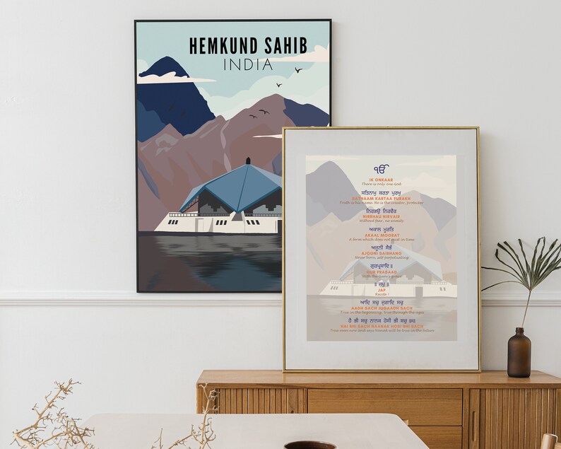 May include: Two framed prints with a mountain and lake scene. The top print says "Hemkund Sahib, India". The bottom print is in Punjabi and features a mountain scene with a building in the foreground.