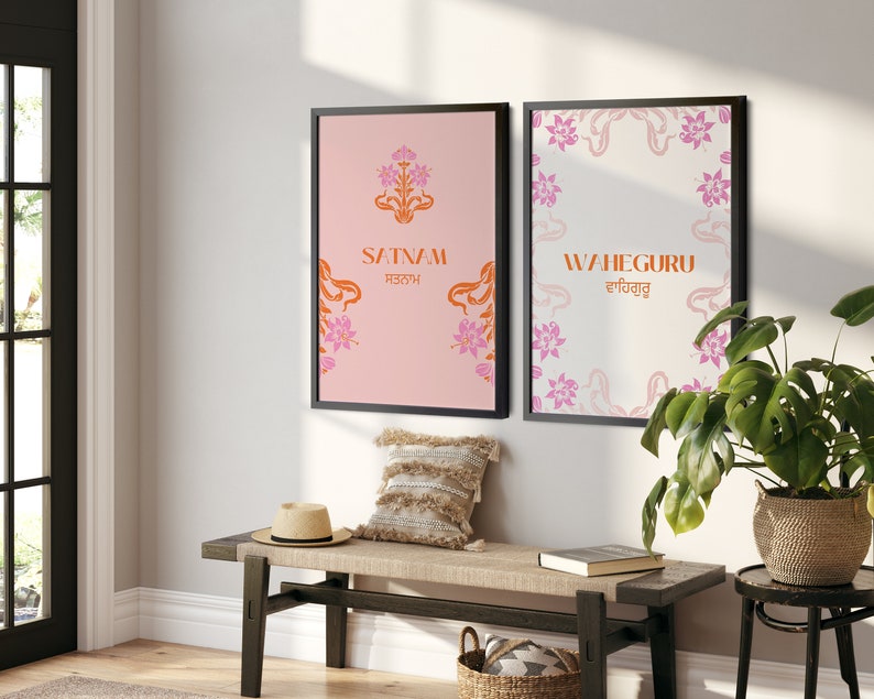 May include: Two framed prints with floral designs and text. The print on the left has a pink background with the text "SATNAM ਸਤਨਾਮ" in orange. The print on the right has a white background with the text "WAHEGURU ਵਾਹਿਗੁਰੂ" in orange.