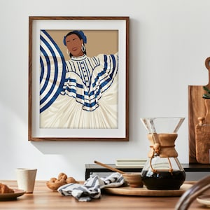 May include: A framed illustration of a woman wearing a white dress with blue and white stripes. The woman has dark skin, brown eyes, and is wearing blue earrings. The background is a light brown colour.