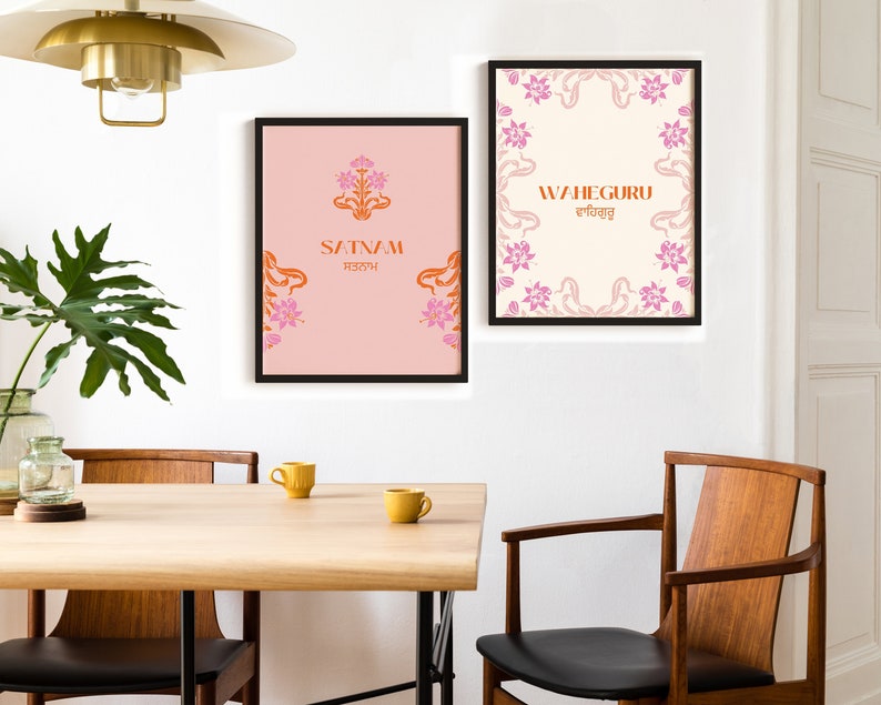 May include: Two framed prints with pink floral borders and orange text. The left print has a pink background and says "Satnam" in orange text. The right print has a white background and says "Waheguru" in orange text with a Gurmukhi script underneath.