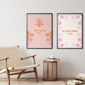 May include: Two framed prints with floral designs and text in orange and pink. The left print says "SATNAM" in orange with the word "ਸਤਨਾਮ" in a smaller font below. The right print says "WAHEGURU" in orange with the word "ਵਾਹਿਗੁਰੂ" in a smaller font below.