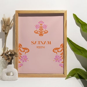 May include: A framed print with a pink background and orange floral design. The text "SATNAM ਸਤਨਾਮ" is centered on the print.