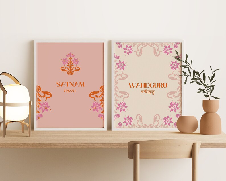 May include: Two framed prints with a peach and cream background. The prints feature floral designs and the words "Satnam" and "Waheguru" in orange and pink.