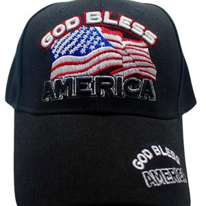 May include: A black baseball cap with an embroidered American flag and the text "God Bless America". The text "God Bless America" is also embroidered on the back of the cap.