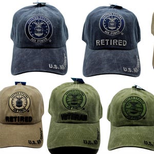May include: A collection of baseball caps in various colors, including navy, khaki, and olive green. Each cap features the United States Air Force emblem and text such as "Veteran" or "Retired". The caps have a distressed look.