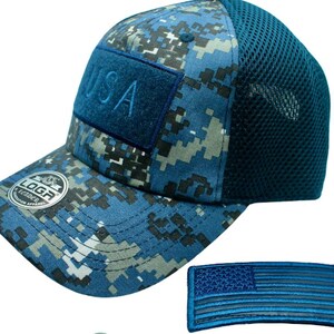 May include: A blue and white camouflage baseball cap with a mesh back. The cap has a blue patch on the front that says "USA". The cap also has a small blue and white American flag patch.