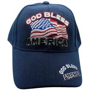 May include: A navy blue baseball cap with an embroidered American flag and the text "God Bless America".