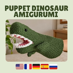 Könnte beinhalten: Eine gehäkelte Dinosaurier-Handpuppe in Grün mit strukturiertem Garnkörper, weit geöffnetem Maul mit weißen Zähnen, rosa Innenraum und kleinen schwarzen Perlenaugen. Der Text PUPPET DINOSAUR AMIGURUMI steht in großen Buchstaben über der Puppe.