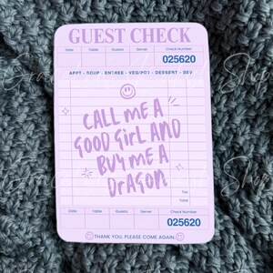 May include: A light purple guest check sticker with the text "GUEST CHECK" at the top. The sticker has the text "CALL ME A GOOD GIRL AND BUY ME A DRAGON". The check number is 025620.