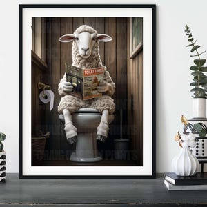 May include: A framed art print depicts a sheep reading "Toilet Times" magazine on a toilet. The image is set in a rustic bathroom with wooden paneling. The humorous artwork includes a toilet roll and a toilet brush.
