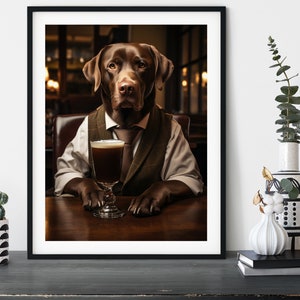 May include: A brown Labrador Retriever dog wearing a waistcoat and tie sits at a table in a pub setting, holding a glass of dark liquid.