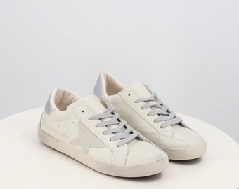Women's Distressed Lace Up Sneaker with Grey Star Detailing in White Faux Leather and Silver Back
