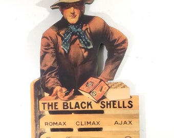 US Cartridge Co. ~ BLACK SHELLS Man Showing Shells Die-Cut Sign with Ajax Shell ~ Reproduction