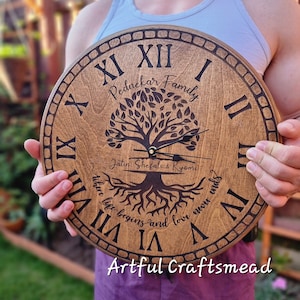 May include: A wooden clock with Roman numerals and a tree design. The clock is engraved with the text "Pednekar Family" and "Jatın. Shefali & Kyomi" and the phrase "where life begins and love never ends".