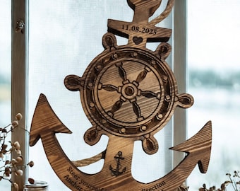 May include: Wooden anchor-shaped wall decor with a ship's wheel design. The anchor has engraved text and a rope for hanging. The date 11.08.2025 is engraved on the top. The bottom of the anchor has the text "Steer yourself in the right direction. Anchor yourself to something great."