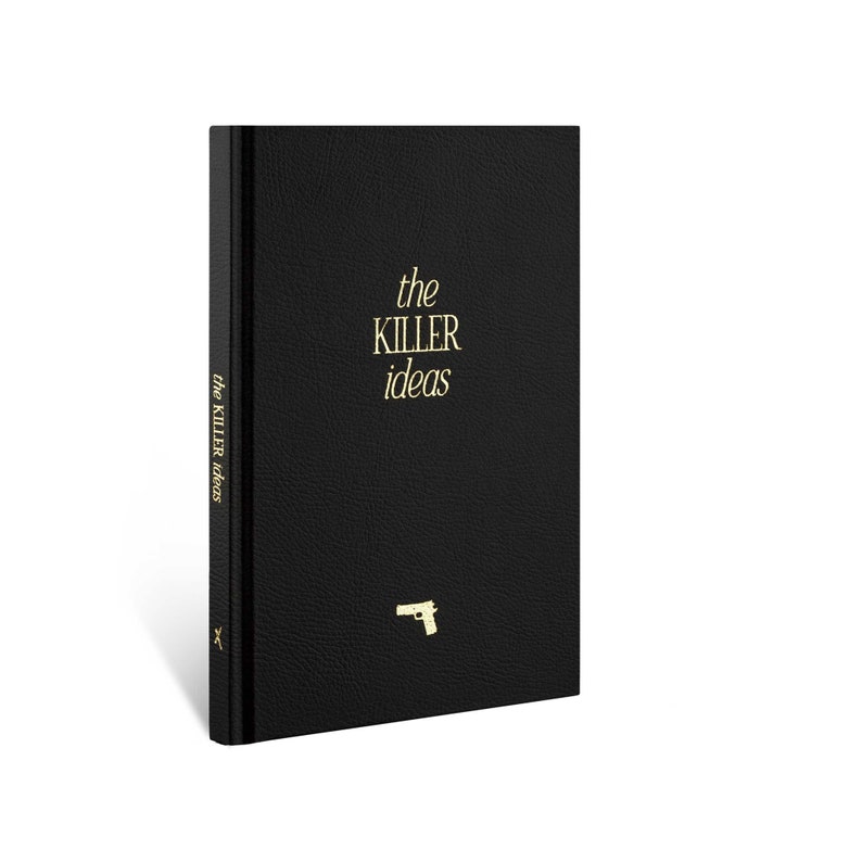 May include: A black leather-bound journal with the words "the KILLER ideas" in gold lettering on the front cover. A small gold gun icon is also on the front cover.