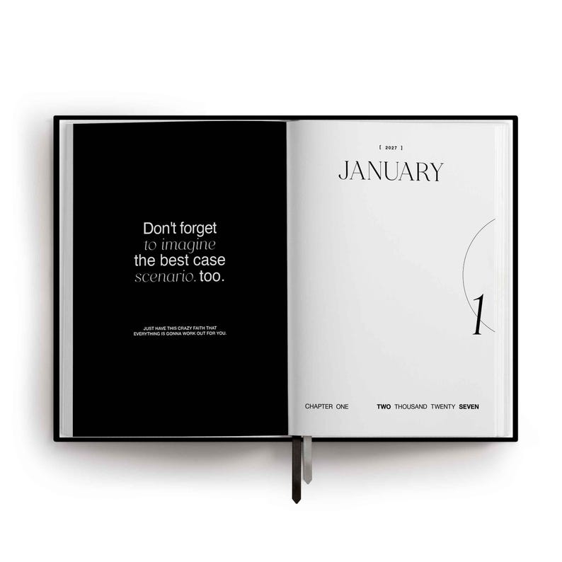 May include: An open planner with a black left page featuring white text that reads: Don't forget to imagine the best case scenario, too. Just have this crazy faith that everything is gonna work out for you. The right page is white with January 2027.