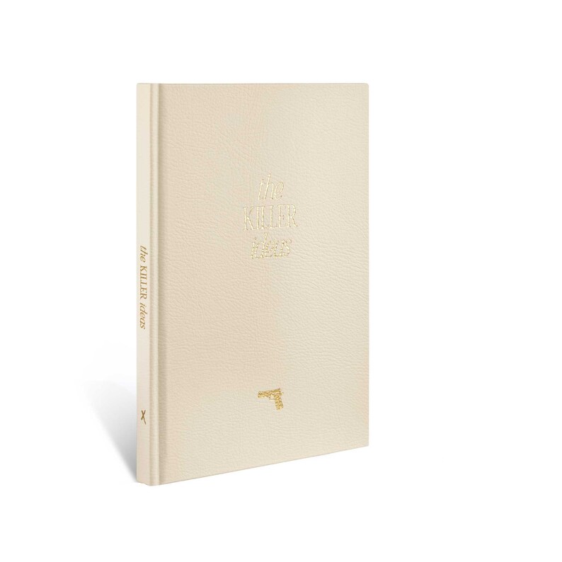 May include: A white leather-bound book with the title "the KILLER" and the text "the KILLER reads" on the spine. A gold gun icon is on the front cover.