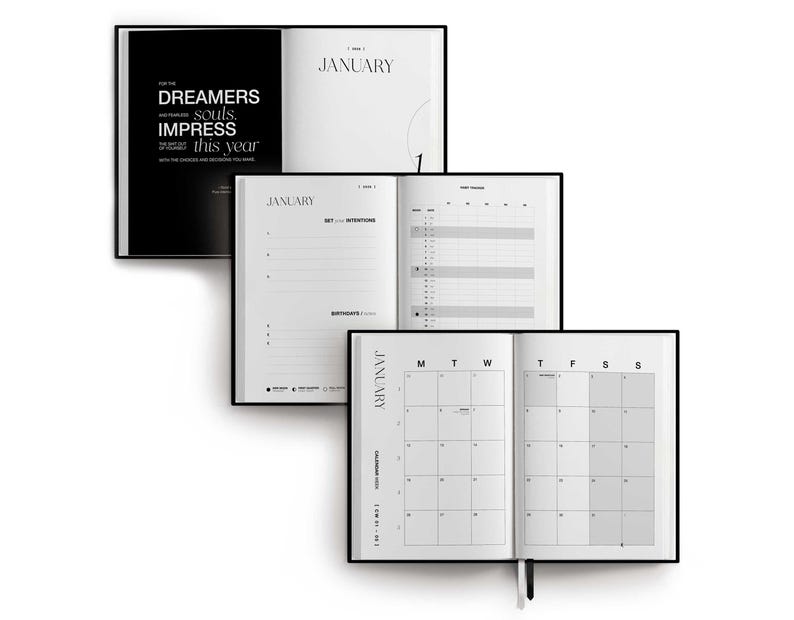 May include: A stack of three open black and white planners. The top planner displays the word "January" and the text "FOR THE DREAMERS, souls, IMPRESS this year". The middle planner shows "January" and a page for setting intentions. The bottom planner shows a calendar.