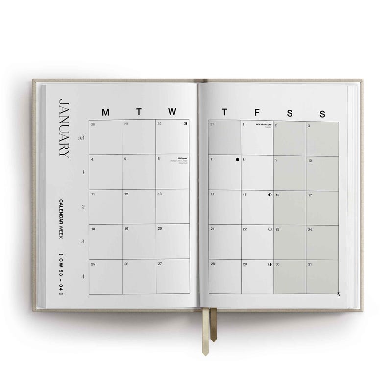 May include: An open planner showing a January calendar spread with a beige cover and two ribbon bookmarks. The grid layout displays days of the week, dates, and moon phase icons. Text includes JANUARY, CALENDAR WEEK, and CW 53-04 in black font.