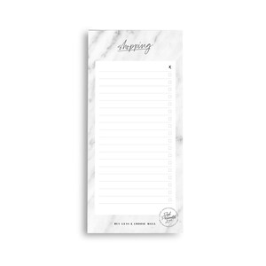 May include: A white marble notepad with a black checklist and the word "shopping" at the top. The notepad has a black and white sticker with the text "Buy Less & Choose Well" and the words "Rad & Remarkable" in a circle.