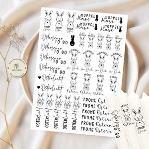 Könnte beinhalten: Eine Bogen mit schwarz-weißen Osterhasen-Stickern. Die Sticker zeigen Hasen mit verschiedenen Sprüchen, darunter "Hoppely Hase", "Osterfeuer to go", "Osterlicht" und "Frohe Ostern".