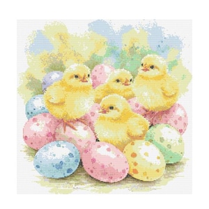 Puede incluir: Cuatro pollitos amarillos acurrucados entre coloridos huevos de Pascua. Los pollitos están rodeados de huevos rosas, azules y amarillos con manchas blancas.