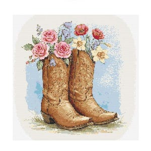 May include: A pair of brown cowboy boots with pink, white, and yellow flowers in the tops.