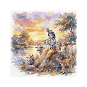May include: A cross-stitch pattern depicts a serene scene with a figure playing a flute, seated on a rock near a river. The figure is surrounded by cows and a calf, with a sunset in the background. The color palette includes blues, yellows, and greens.