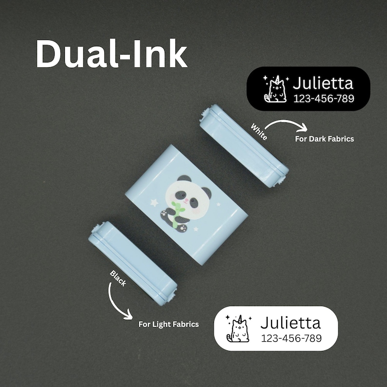 May include: A light blue dual-ink label maker with a panda design, accompanied by two ink cartridges, one black for light fabrics and one white for dark fabrics. Includes labels with the name "Julietta" and a phone number.