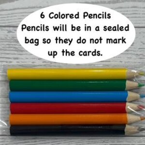 May include: Six colored pencils in a clear plastic bag. The pencils are yellow, green, blue, red, orange, and black. Text on the image reads "6 Colored Pencils. Pencils will be in a sealed bag so they do not mark up the cards."