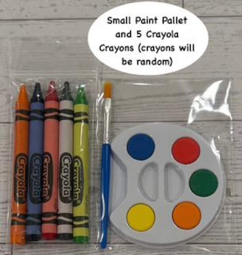 May include: A clear plastic bag contains a small white paint palette with six colored paint wells, five Crayola crayons, and a paintbrush. The crayons are orange, blue, red, white, and yellow. Text on the image reads "Small Paint Pallet and 5 Crayola Crayons (crayons will be random)".