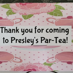 May include: Pink and green tea party favor box with a white label that says "Thank you for coming to Presley's Par-Tea!"