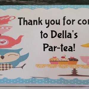 May include: A blue and white thank you card with a blue owl holding a stack of teacups and a teapot. The card says "Thank you for coming to Della's Par-tea!"
