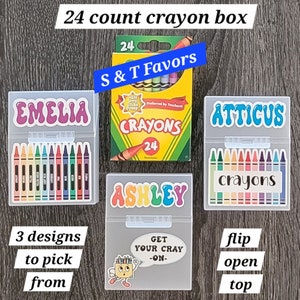 May include: Three clear plastic boxes with 24 count crayons inside. The boxes have different designs on the front. One box has the name "EMELIA" on the front, another has the name "ATTICUS" on the front, and the third has the name "ASHLEY" on the front. The boxes are labeled "24 count crayon box" and "S & T Favors".