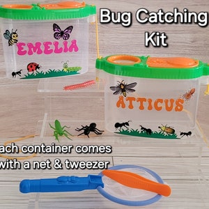 May include: Bug catching kit with two clear plastic containers, one labeled "EMELIA" and the other "ATTICUS". Each container has a green lid and comes with a net and tweezers.