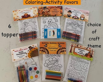 May include: Six Thanksgiving coloring activity favor bags, each featuring a themed paper topper with text like Happy Thanksgiving, a coloring sheet with turkey or holiday illustrations, and a small set of crayons or a paint palette.