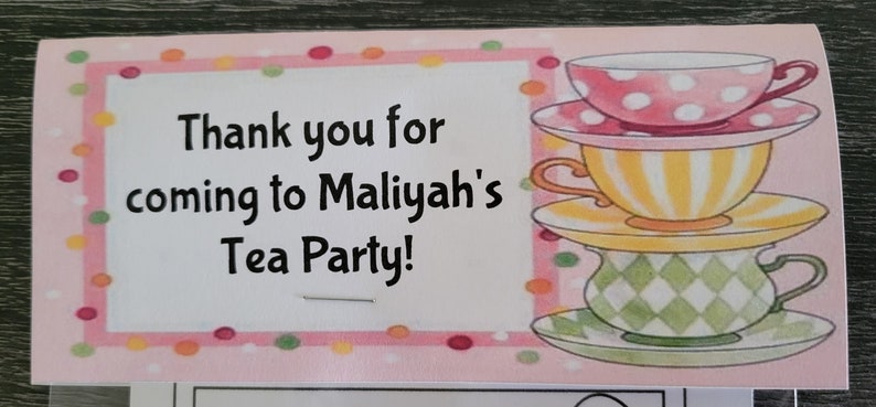 May include: Pink and white thank you card with a stack of three teacups and saucers. The card says "Thank you for coming to Maliyah's Tea Party!"