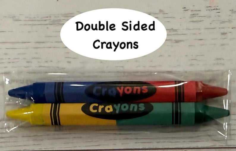 May include: Two double-sided crayons in a clear plastic package. One crayon is blue and red, the other is yellow and green. The word "Crayons" is printed on each crayon. The package has the text "Double Sided Crayons".