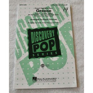 May include: Sheet music for "Choral Highlights from Grease" in the Discovery Pop Series. The cover features a green and white design with the title and song list. Arranged by Roger Emerson, available for SATB, 3-Part Mixed and 2-Part.