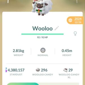 May include: A screenshot from a mobile game featuring a Wooloo character with a festive hat. The image displays the character's stats, including weight (2.81kg) and height (0.45m), along with game data like Stardust and Candy.