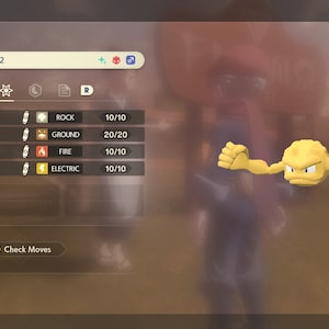 Może przedstawiać: Żółty Pokemon Geodude z gry wideo, poziom 22. Postać ma cztery ruchy: Rock Slide, Bulldoze, Fire Punch i Thunder Punch. Ruchy są wymienione wraz z ich typem i liczbą punktów na 10.
