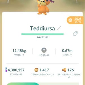 May include: A mobile game screen featuring a Teddiursa character wearing a witch hat. The character has a CP of 540, weighs 11.48kg, and is 0.67m tall. The screen displays options to power up or evolve the character.