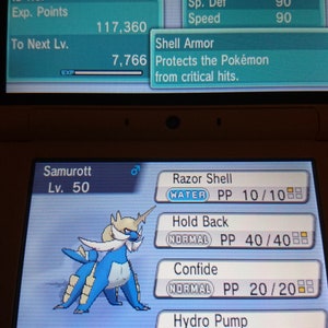 Pode incluir: Um personagem Pokémon Samurott azul e branco na tela de um Nintendo DS. O Pokémon é de nível 50 e tem os movimentos Concha Afia, Retenção, Confiança e Bomba de Água. A tela também mostra as estatísticas e habilidades do Pokémon.