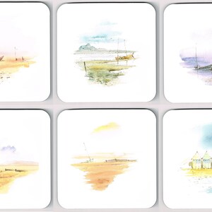 May include: A set of six square coasters, each with a watercolour painting of a coastal scene. The images depict boats, beaches, and soft colour palettes of blues, yellows, and greens. The coasters are designed to protect surfaces from heat and moisture.