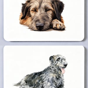 May include: Two rectangular coasters featuring detailed illustrations of dogs. The top coaster shows a tan and black shaggy dog sleeping with eyes closed. The bottom coaster displays a grey and black shaggy dog lying down with its tongue out.