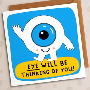 May include: A blue and white cartoon eye with a smiling face and the text "eye will be thinking of you!" on a yellow background.