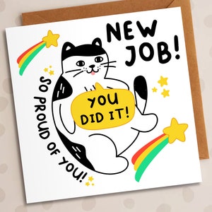 May include: A white and black cat with a yellow speech bubble that says "You Did It!" The cat is holding the speech bubble in its paws. The cat is surrounded by rainbow stars and the text "New Job! So Proud of You!"