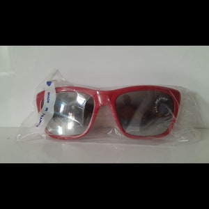 Puede incluir: Gafas de sol rojas con lentes espejados y una etiqueta que dice "Made in France" y "All Weather".
