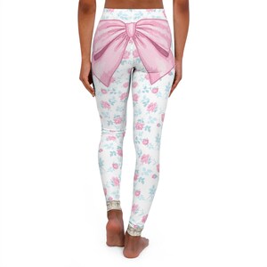 May include: White leggings with a pink bow on the back and a floral pattern of pink and blue roses.
